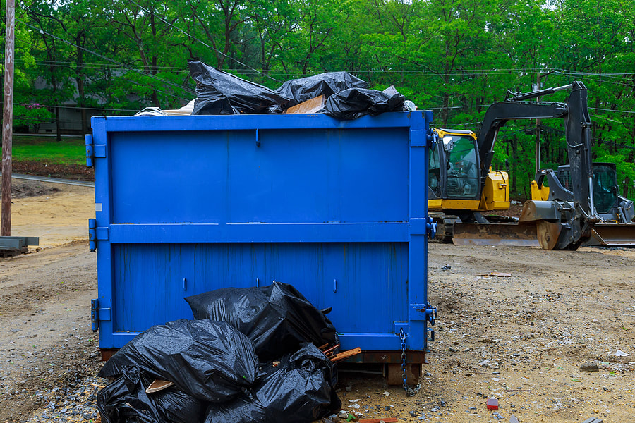 In Danbury, CT, a dumpster is filled with waste.
