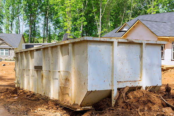 During a renovation in Danbury, Connecticut, a dumpster is outside a house.