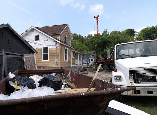 In Danbury, CT, an industrial dumpster is stuffed with the trash of a renovation project.
