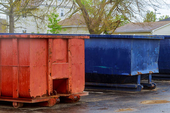 Two dumpsters are parked along the road in Danbury, CT.