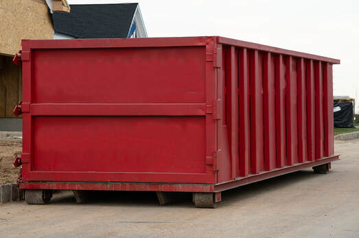 A large garbage dumpster is placed in Danbury, Connecticut.
